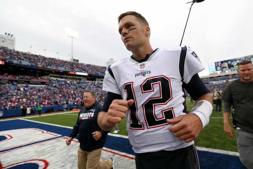 ORCHARD PARK, NEW YORK - SEPTEMBER 29: Tom Brady #12 of the New England Patriots runs off...