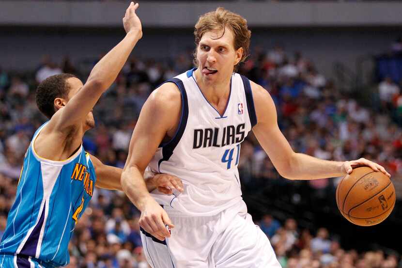 Dallas Mavericks power forward Dirk Nowitzki (41) drives towards the basket with his tongue...