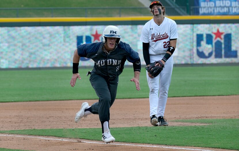 Flower Mound Sam Erickson, (21), runs for home as Cypress Woods Ethan Farris, (22), looks on...