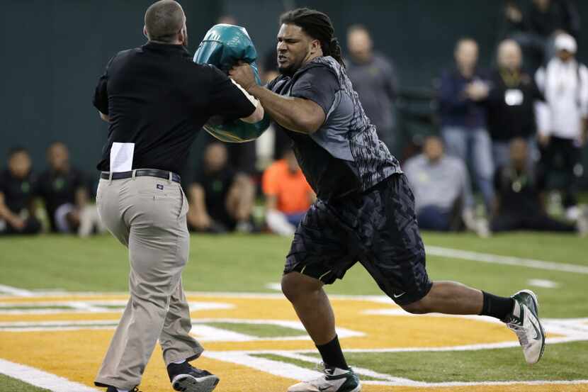 Baylor offensive lineman Cyril Richardson, right, works out during pro day for NFL football...