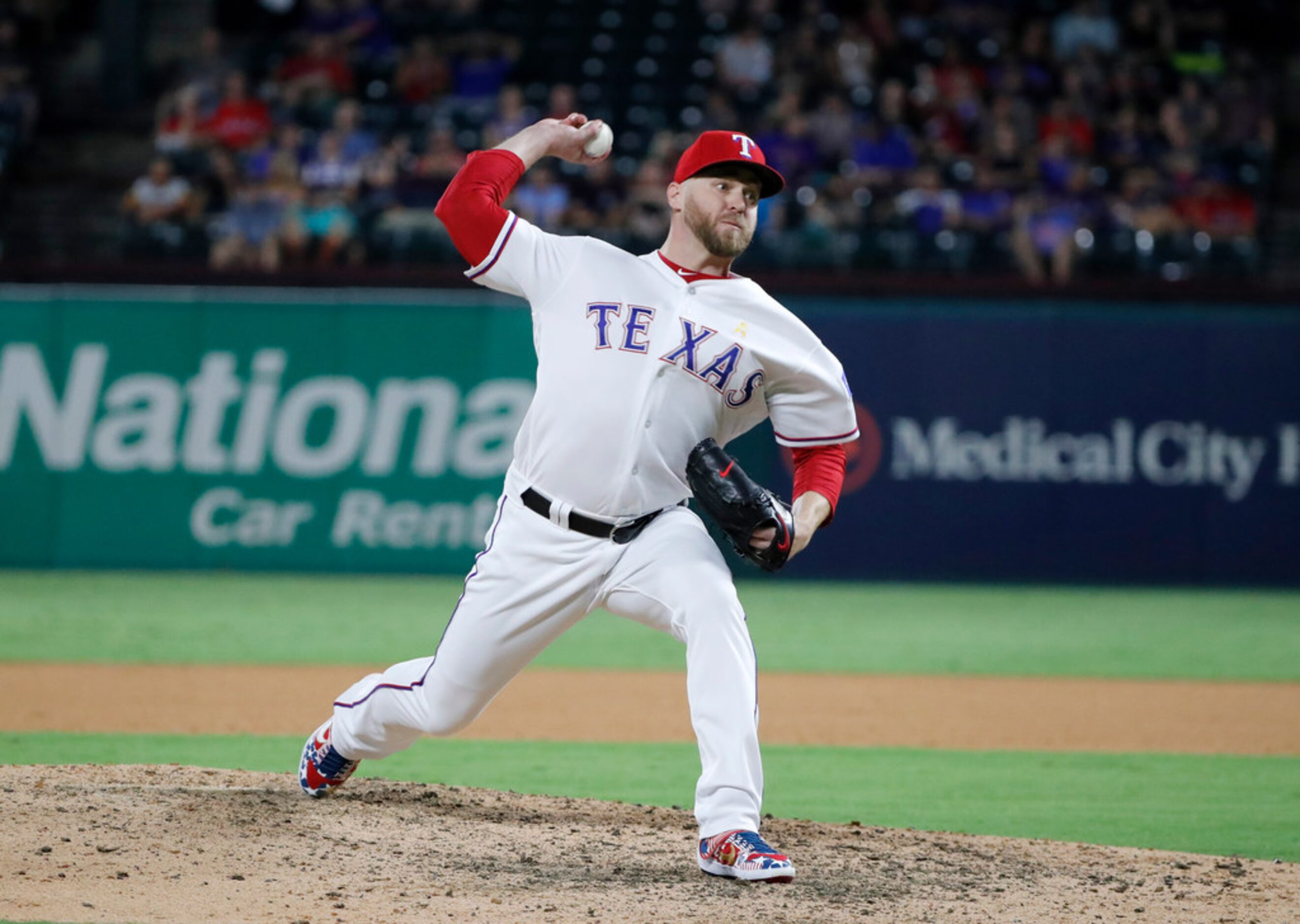 Texas Rangers relief pitcher Shawn Kelley throws to the Oakland Athletics in the eighth...