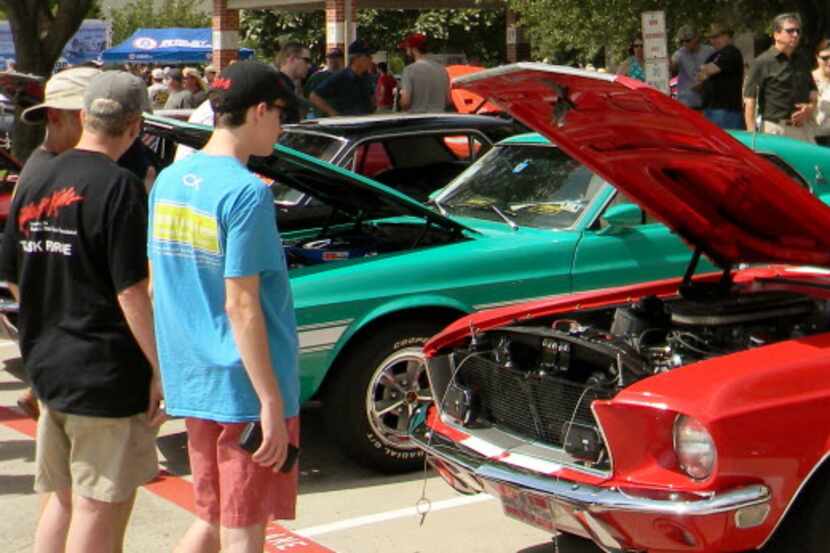 Car enthusiasts look at classic Mustangs at the 6th annual Shelby Car Show in 2015 in Plano....
