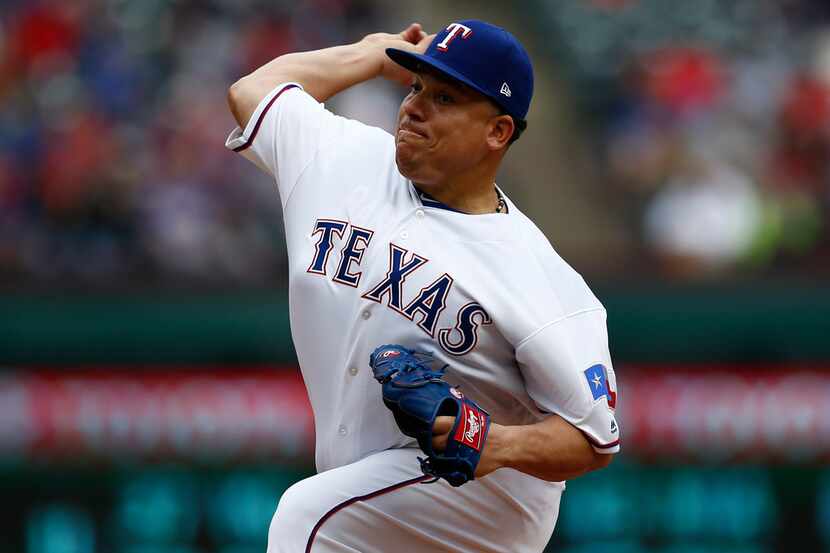 Texas Rangers relief pitcher Bartolo Colon (40) delivers a pitch to the Toronto Blue Jays...