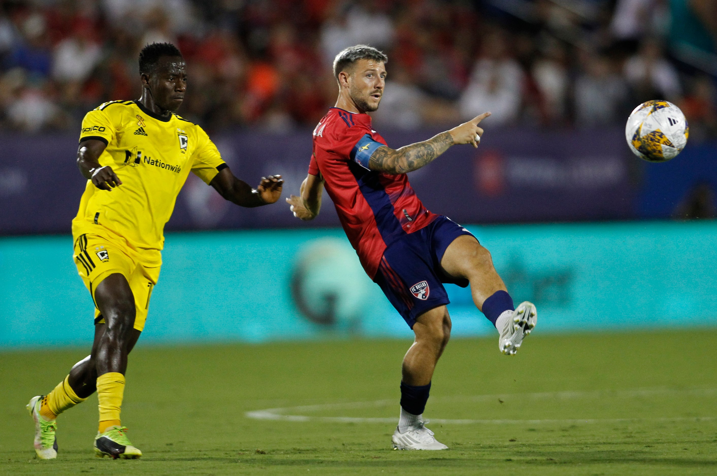 FC Dallas midfielder Paul Arriola (7) clears the ball as Columbus midfielder Yaw Yeboah (14)...