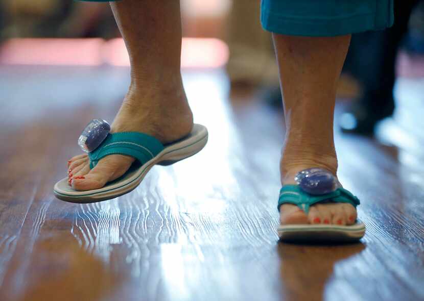 Betty Means wears step counters on her sandals during a line dancing class.