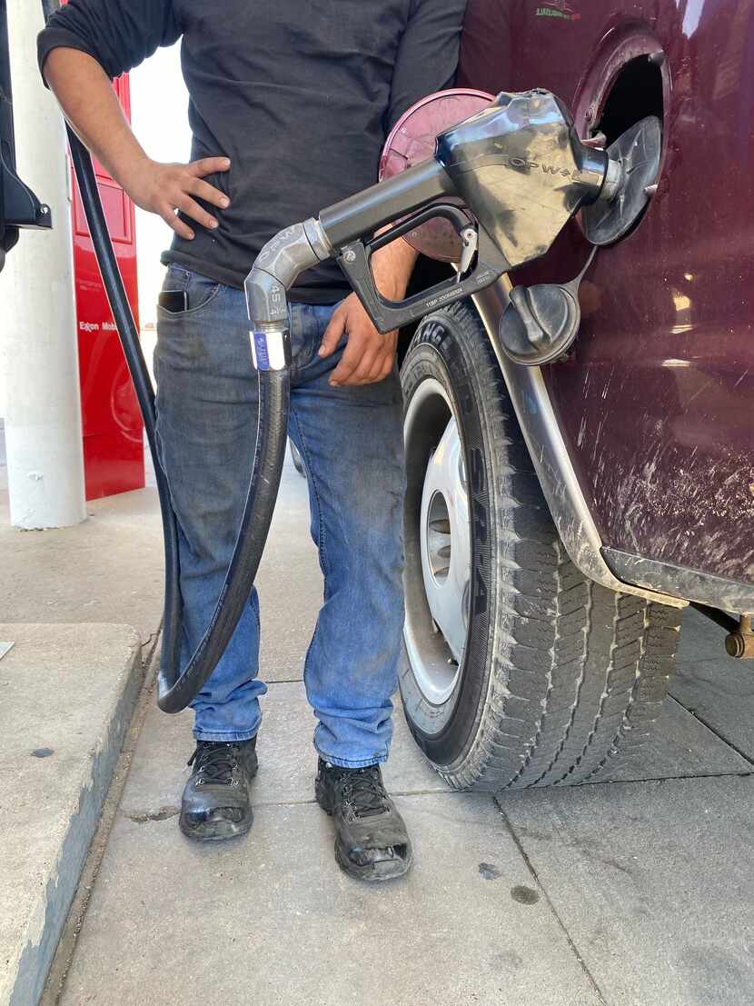 Carlos Joaquin fuels up his SUV. Driving is a risk that must be taken, he says.