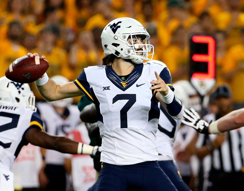 FILE - In this Oct. 21, 2017, file photo, West Virginia quarterback Will Grier (7) passes in...
