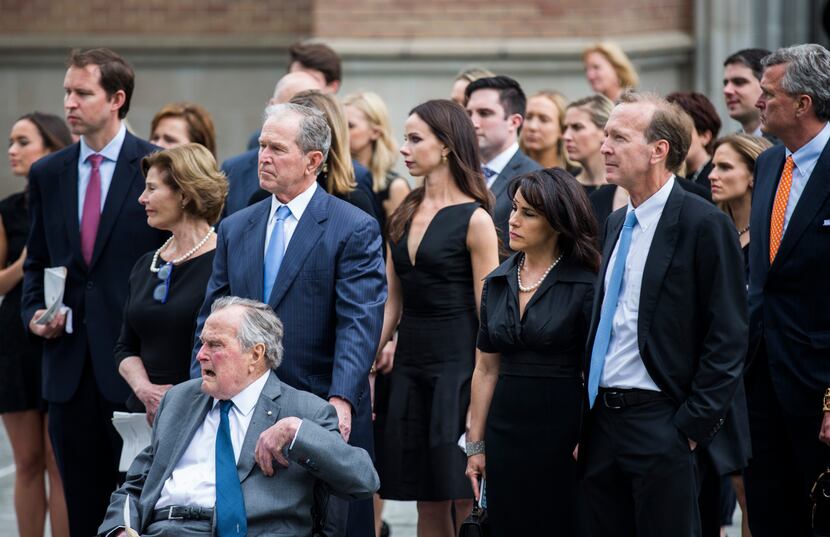 Former President George W. Bush escorts his father, former President George H.W. Bush, out...