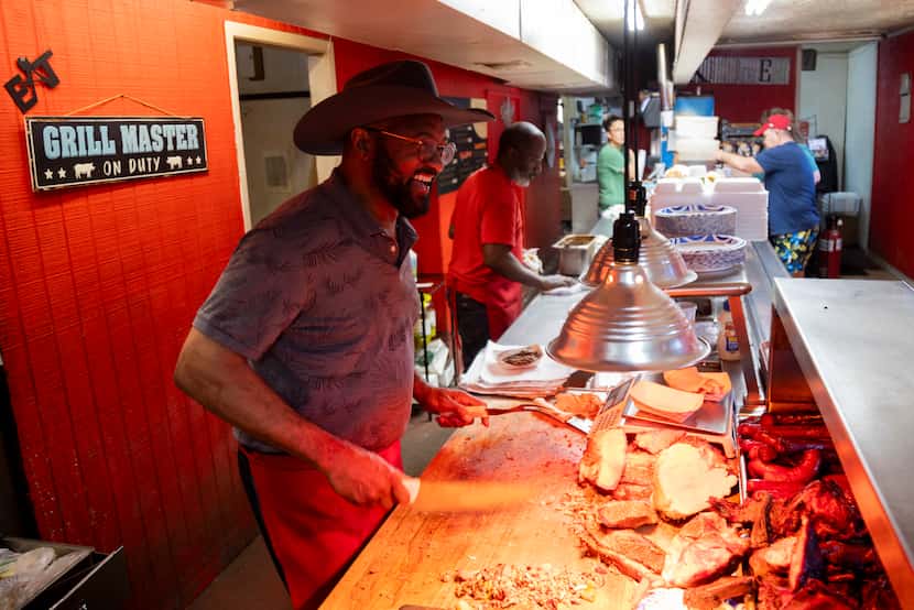 Bruce Barrett, owner of Shep's BBQ & Catering in Palestine, Texas, serves lunch customers...