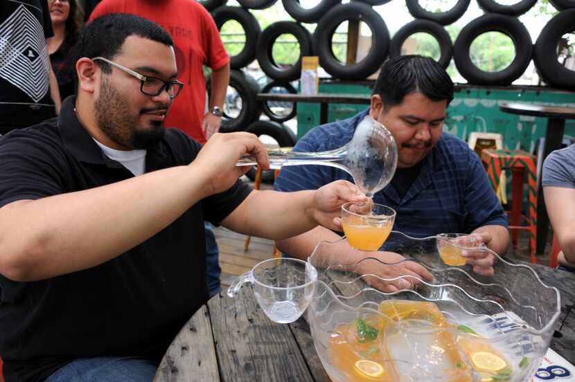 Roberto Rodriguez serves a glass of brunch punch at Truck Yard in Dallas. Nice job.