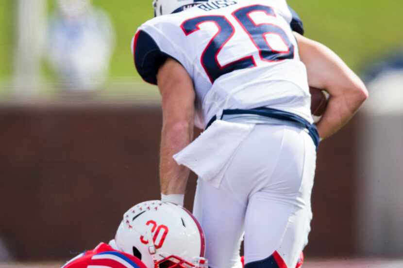 Southern Methodist Mustangs linebacker Shaine Hailey (30) tackles Connecticut Huskies wide...