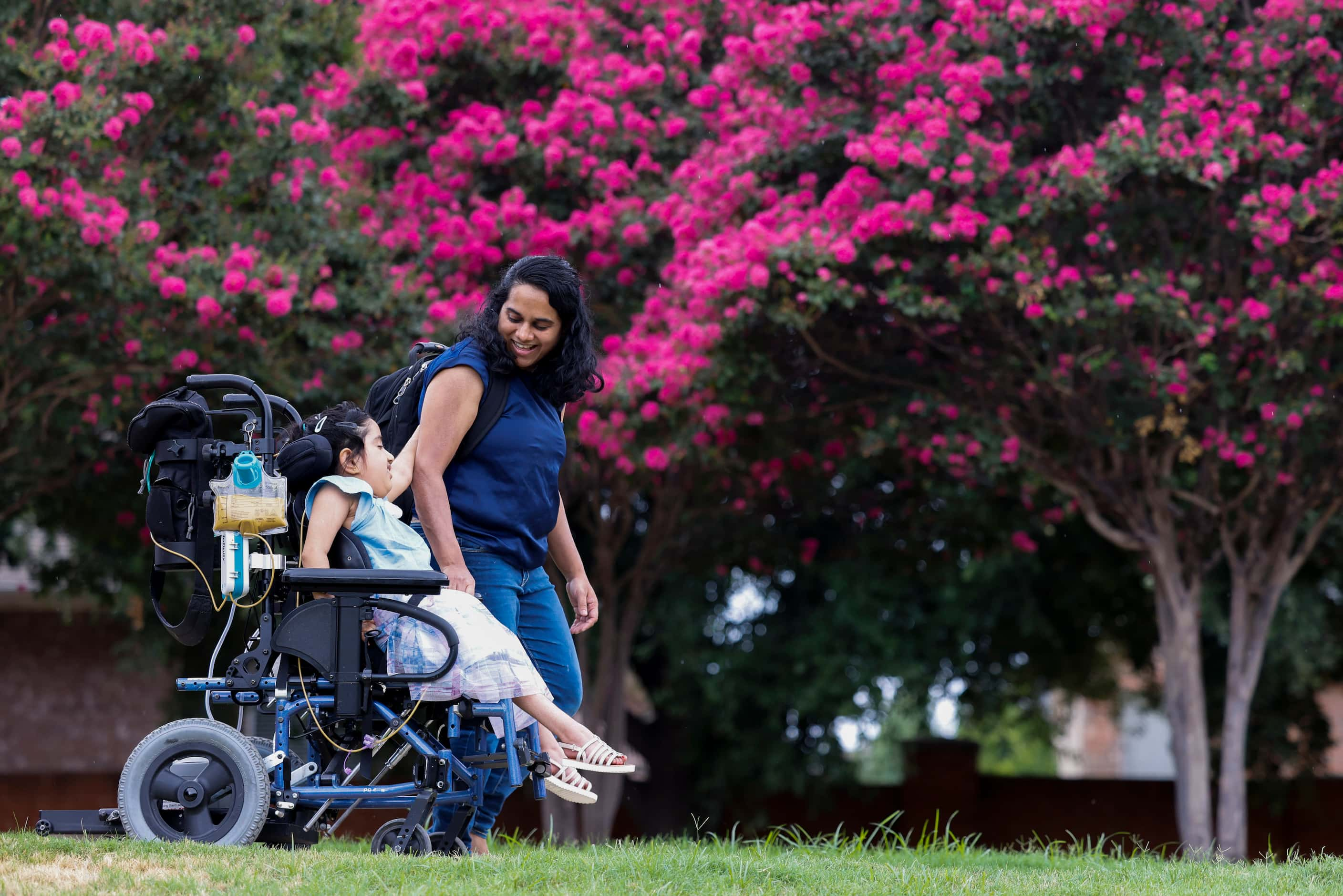 Aadya Warrier gestures towards her mother Anju Govind as they go down a slope to a park on...