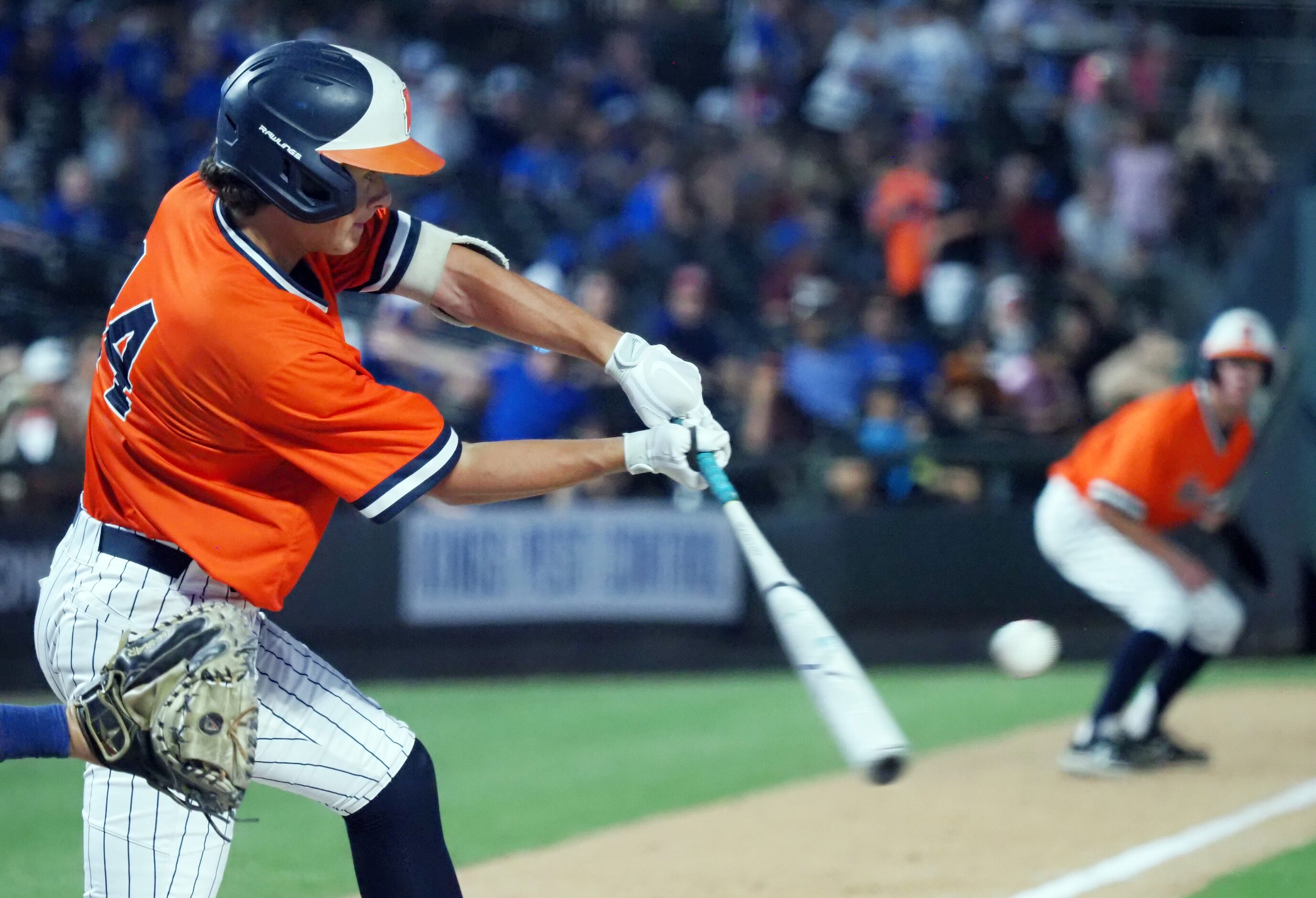 Frisco Wakeland batter Owen Cassano (left) hits the ball against Georgetown in the UIL...