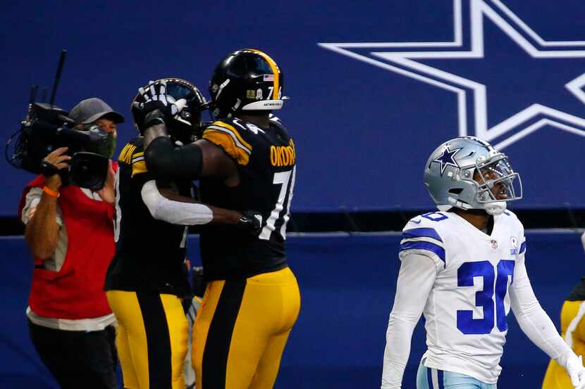 Dallas Cowboys cornerback Anthony Brown (30) looks at the video replay after being scored on...