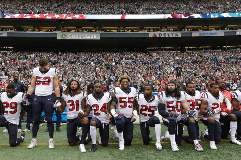 FILE - In this Oct. 29, 2017, file photo, Houston Texans players kneel and stand during the...