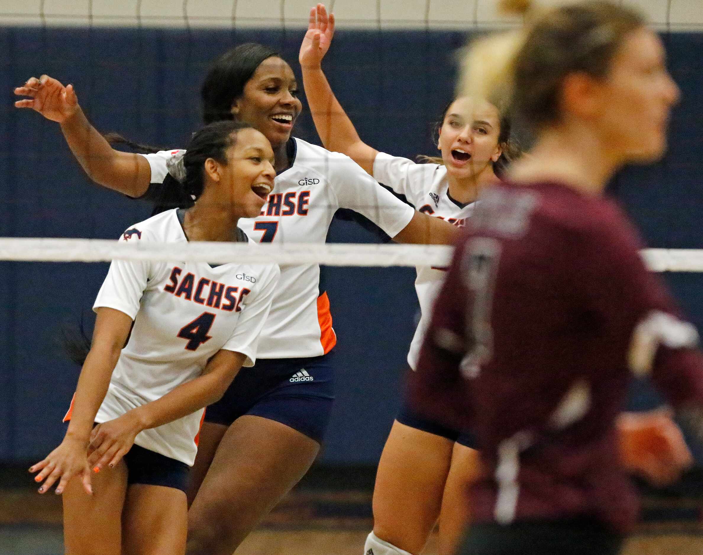 Sachse High School outside hitter Shaliyah Rhoden (4) celebrates with team mates after a...
