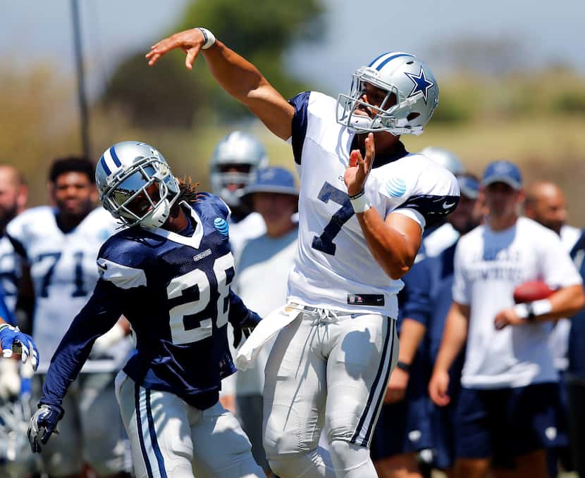 Dallas Cowboys quarterback Jameill Showers (7) releases a pass as defensive back Dax Swanson...