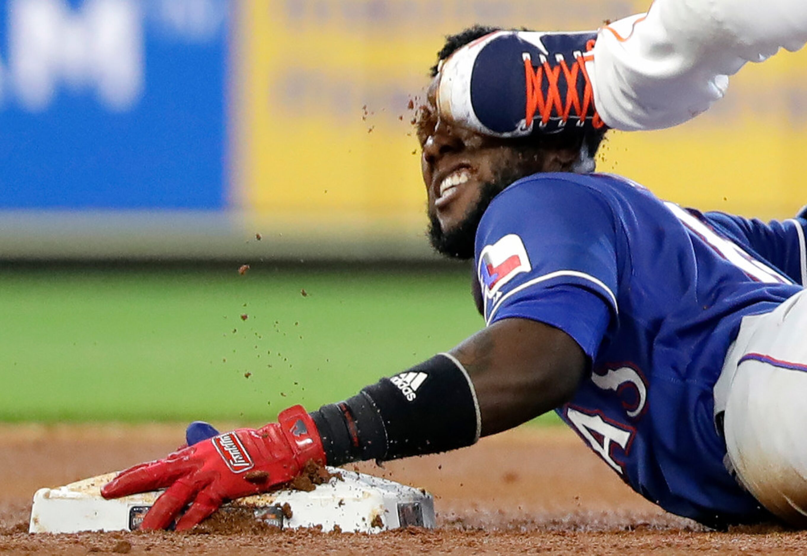 Houston Astros second baseman Yuli Gurriel steps on the face of Texas Rangers' Jurickson...