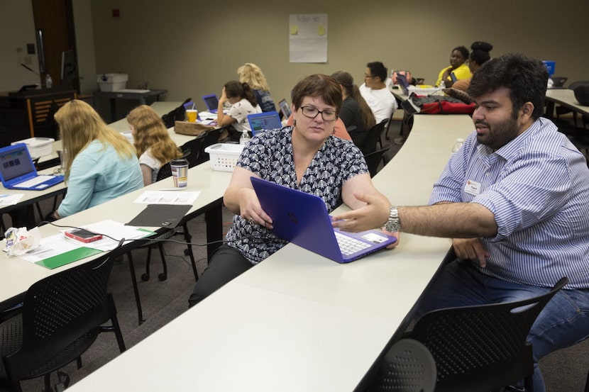 Beverly Lewicki receives help from Fagun Vasavada during a week-long UTeach programming and...