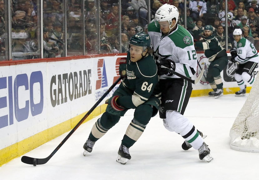 Minnesota Wild center Mikael Granlund (64) and Dallas Stars center Radek Faksa (12) battle...