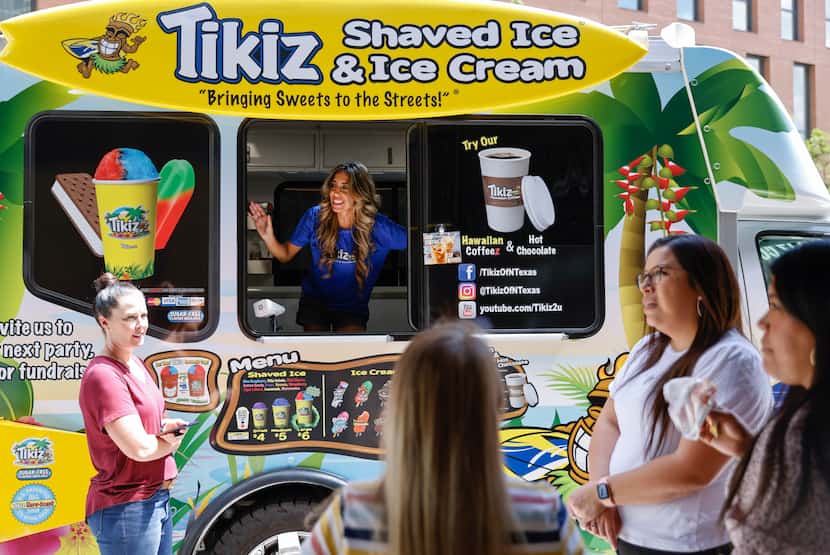 Shave ice and ice cream truck owner Gabriela Ávila took orders from customers during an...
