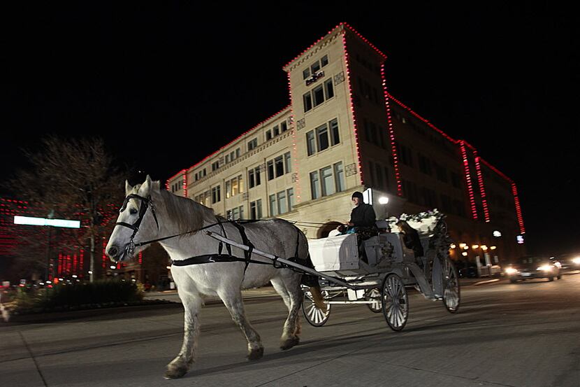Christmas in the Square featured horse drawn carriage rides at Frisco Square on Sunday,...