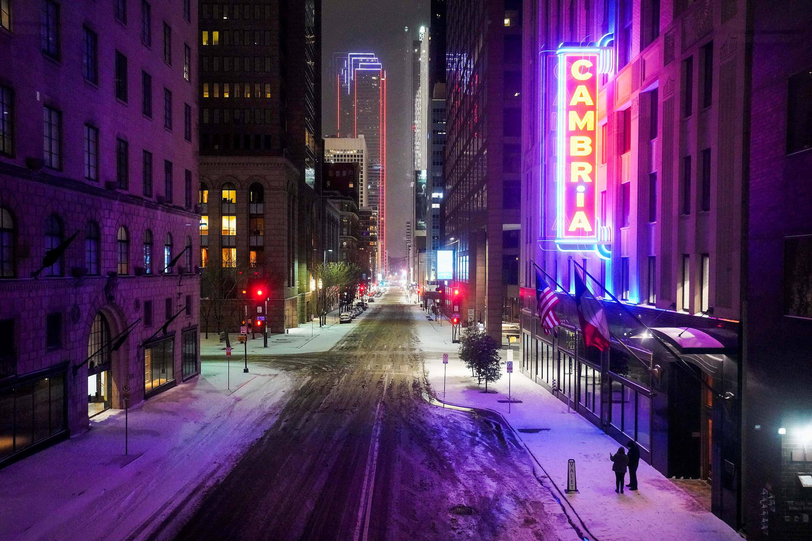 Elm Street is quiet in front of the Cambria Hotel as a winter storm brings snow and freezing...