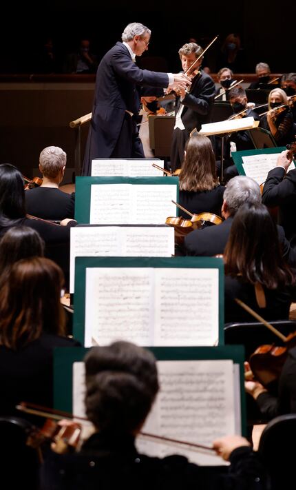 Violinist James Ehnes (standing, right) performs with the Dallas Symphony Orchestra under...