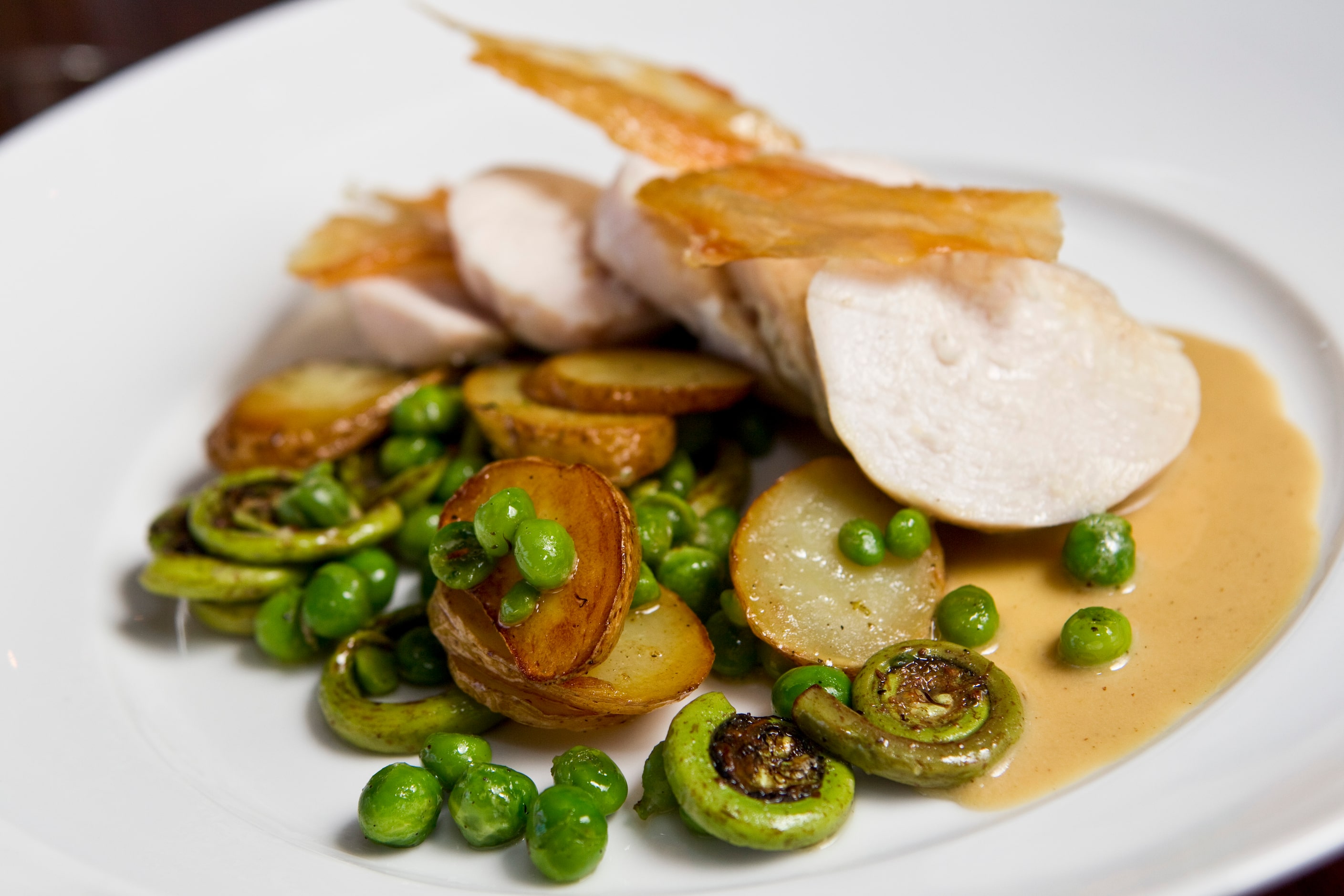 CHICKEN WITH ENGLISH PEAS AND FIDDLEHEAD FERNS AT BOLSA -- Jeff Harris’ creation was the...