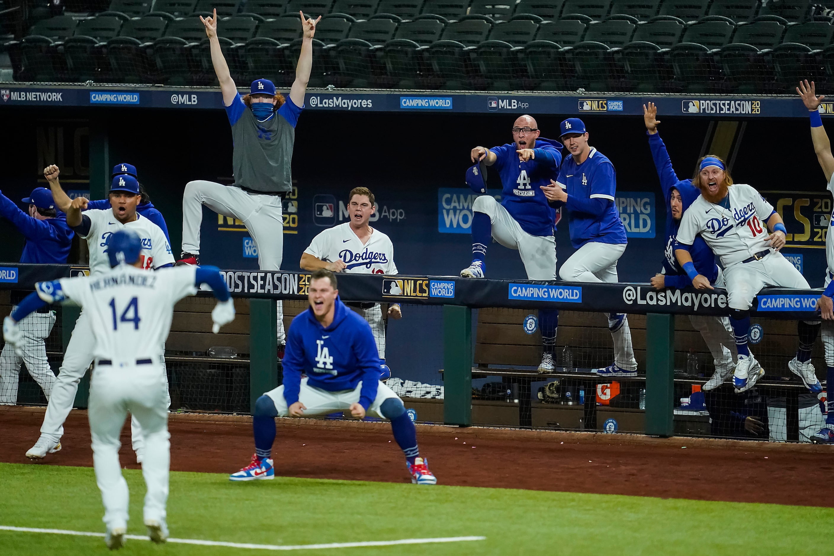 The Los Angeles Dodgers dugout erupts after pinch hitter Enrique Hernandez (14) hit a...