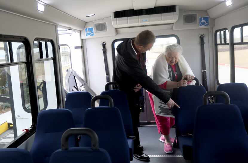 Envoy America driver Kris Werner helps Jeannyne Reston select a seat on the bus at The...