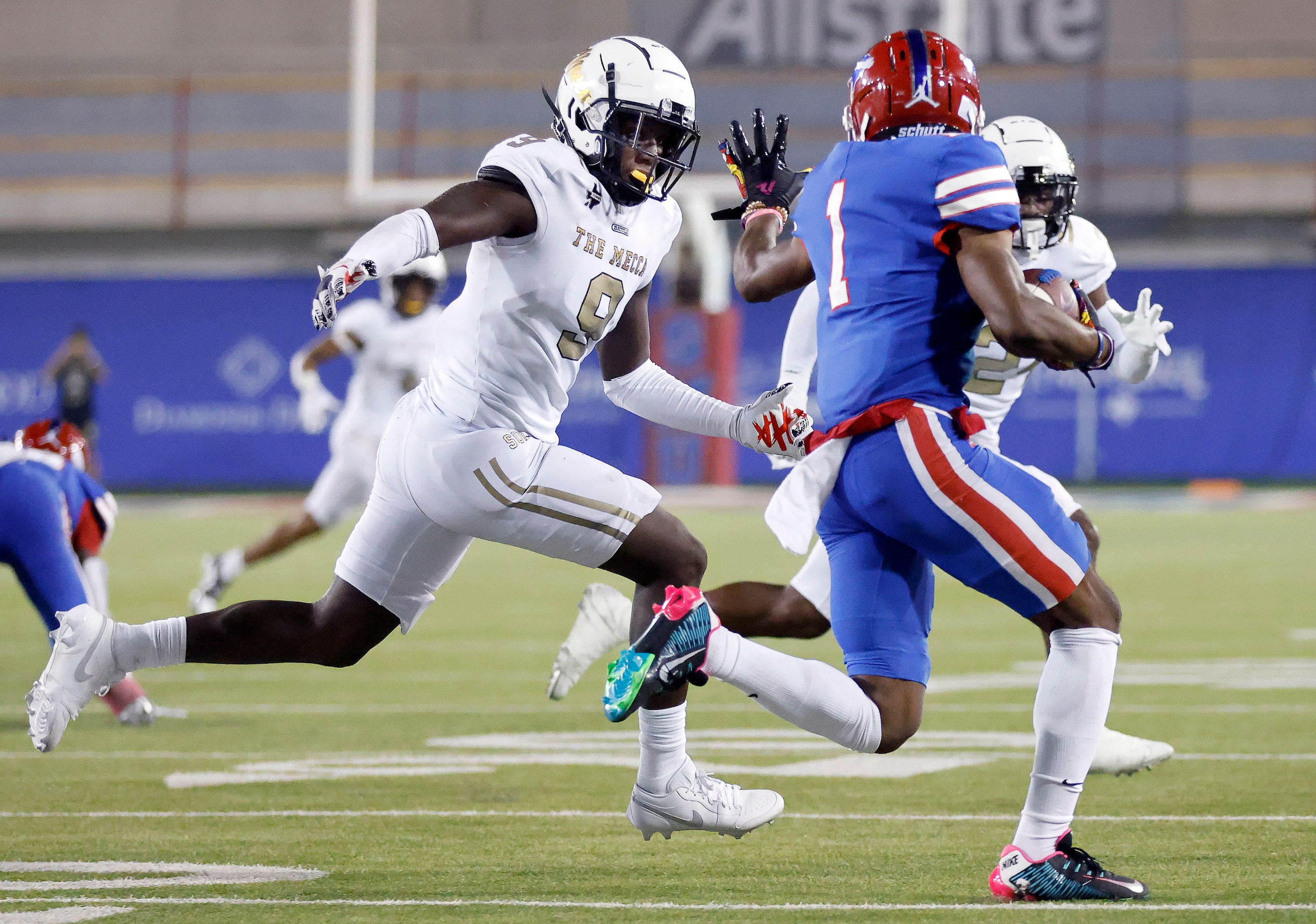 Duncanville’s Dakorien Moore (1) bobbled the snap on a third quarter punt and scrambled for...