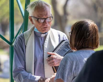 The Rev. Timothy Gollob speaks with Judy Lewis at the funeral of his longtime friend and...
