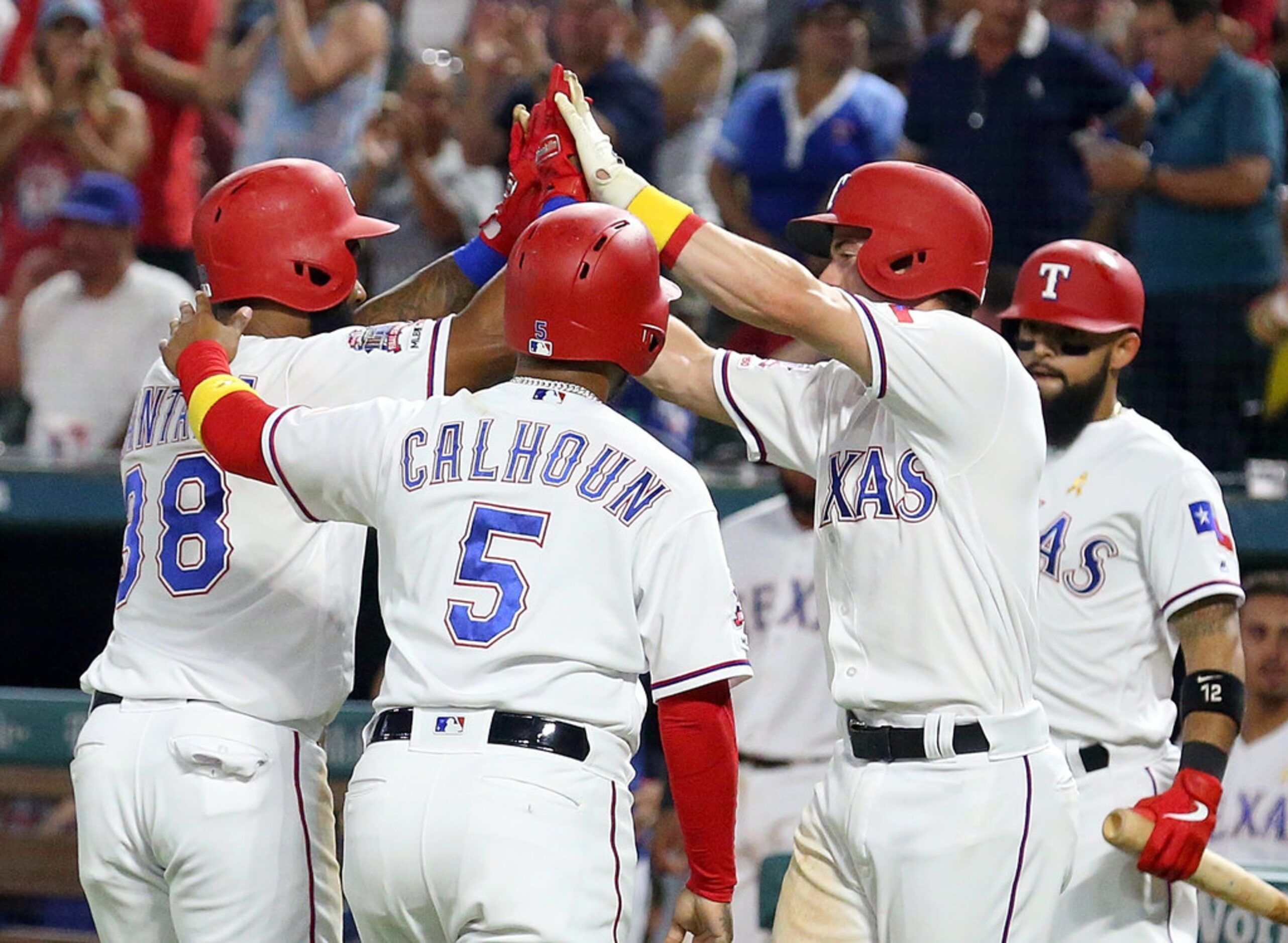 ARLINGTON, TEXAS - SEPTEMBER 13: Danny Santana #38 of the Texas Rangers is greeted by Willie...