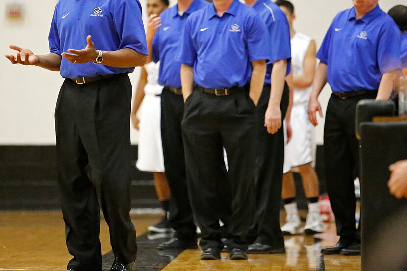 Plano West High School's Head Basketball Coach Anthony Morgan (left) reacts with his bench...