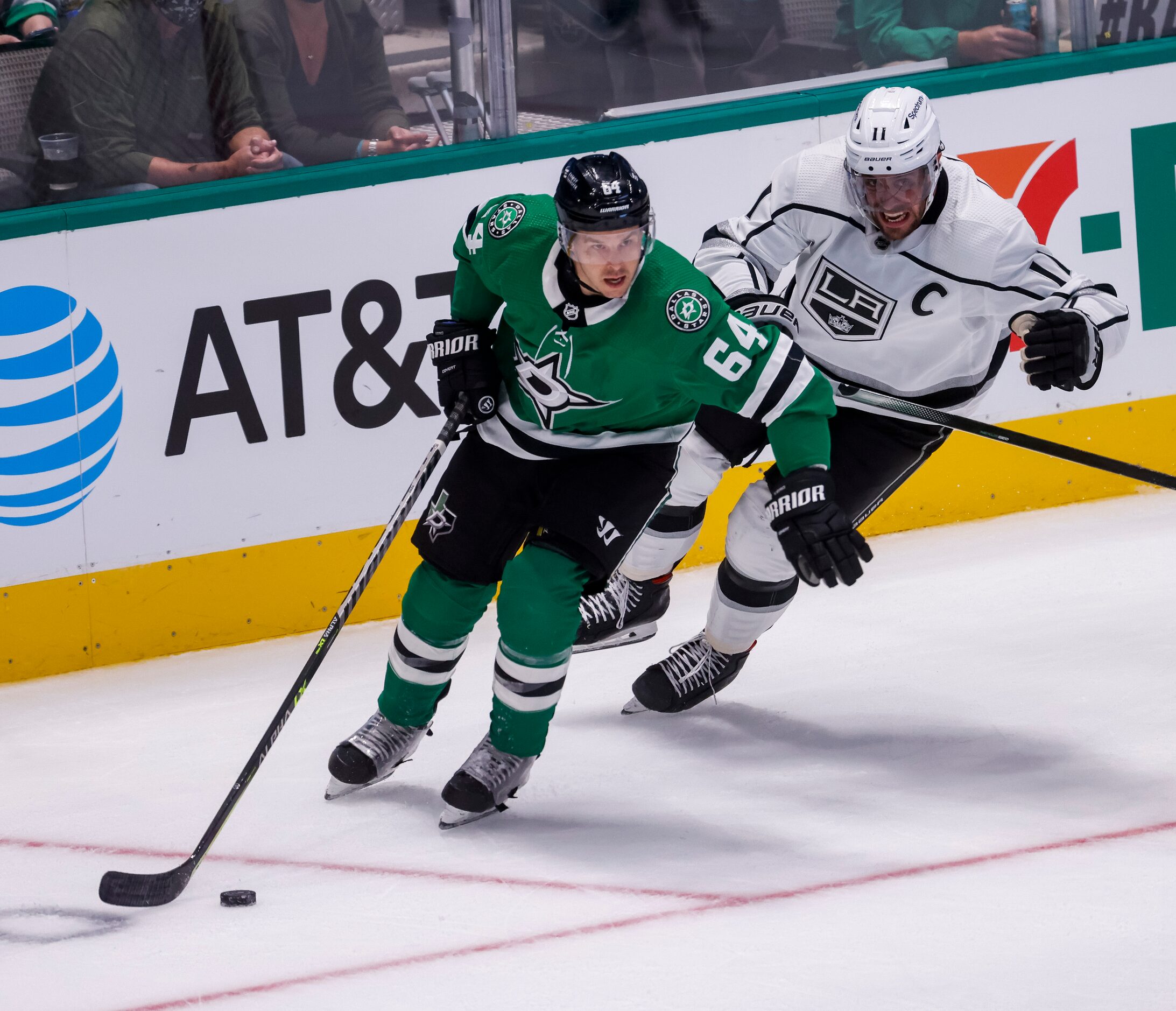 Los Angeles Kings center Anze Kopitar (11) chases after Dallas Stars center Tanner Kero (64)...