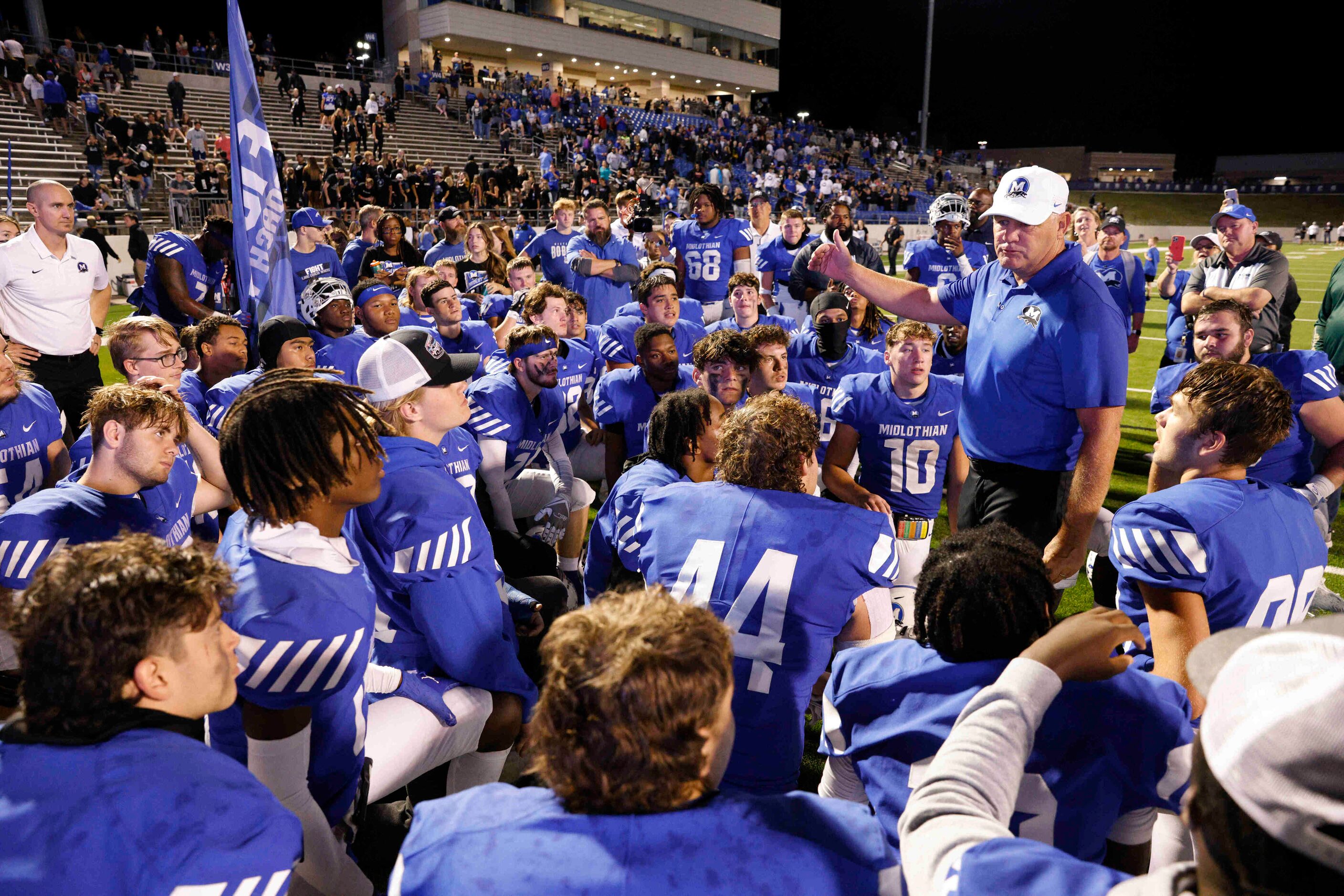 Midlothian head coach Doug Wendel speaks to his team after beating Red Oak at Midlothian ISD...