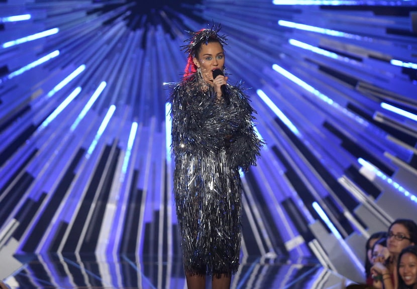 Host Miley Cyrus speaks at the MTV Video Music Awards at the Microsoft Theater on Sunday,...