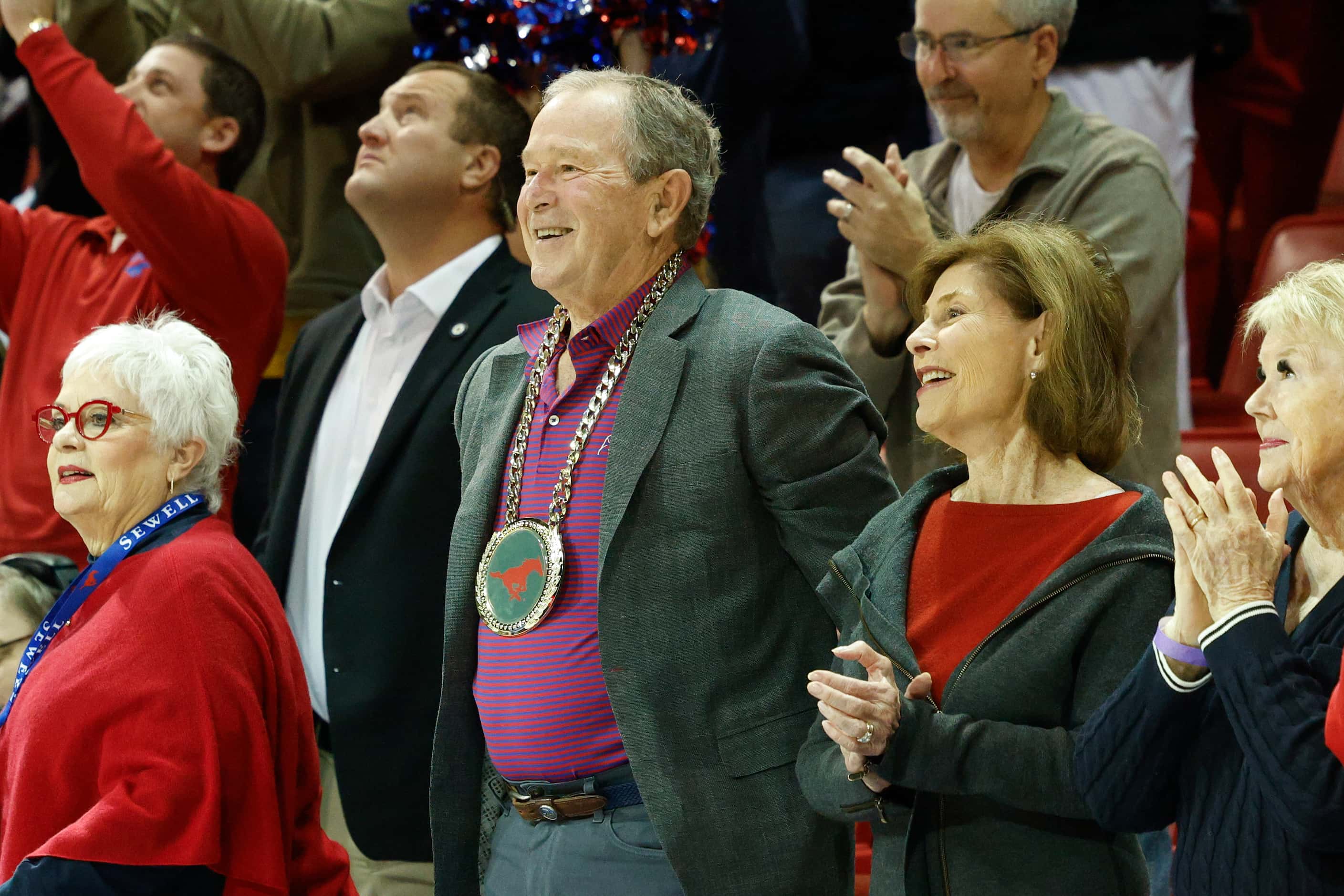 Former President George W. Bush wears a gold replica SMU chain as he’s recognized alongside...