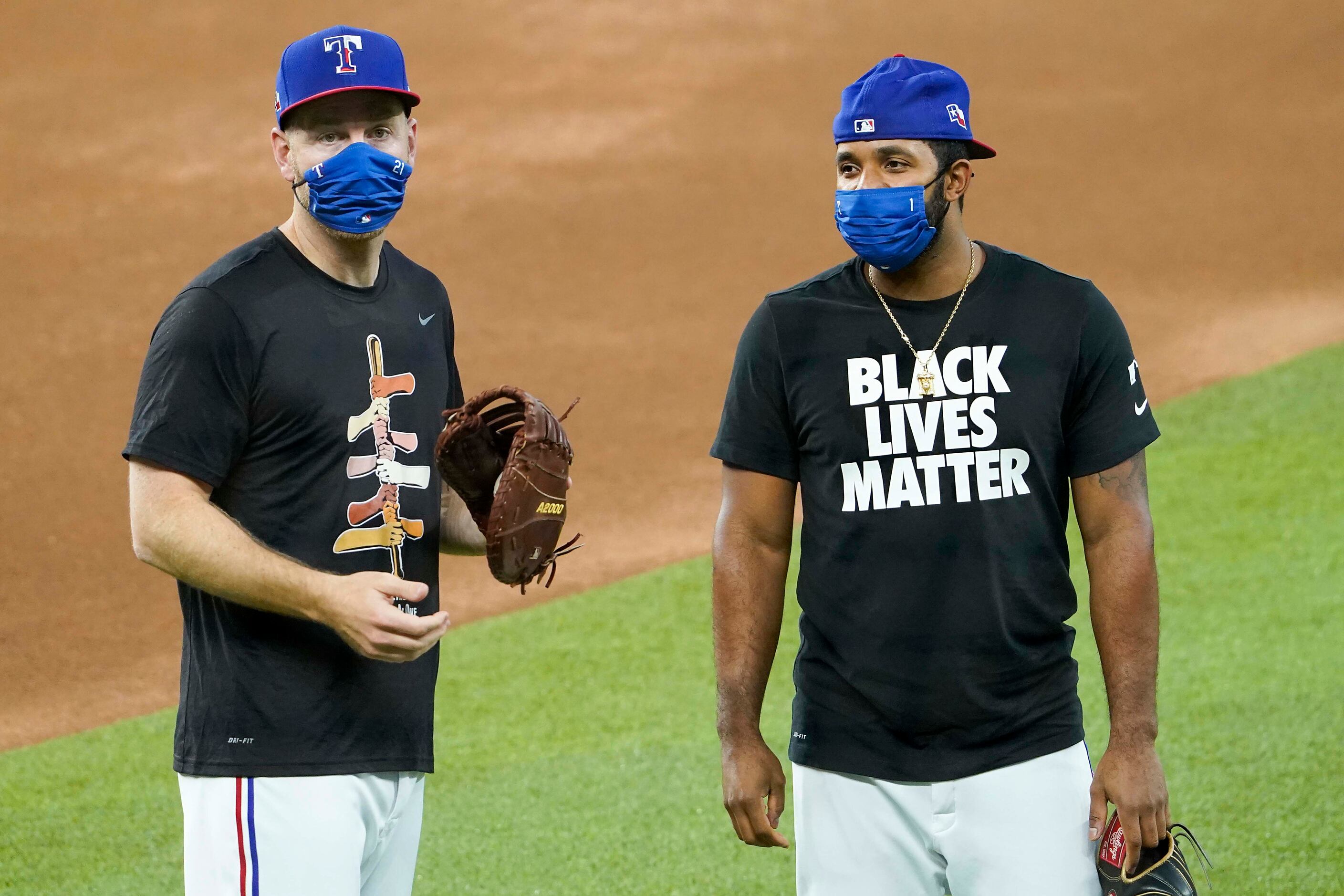 Todd Frazier (left) and Elvis Andrus wear t-shirts in support of racial justice as they warm...