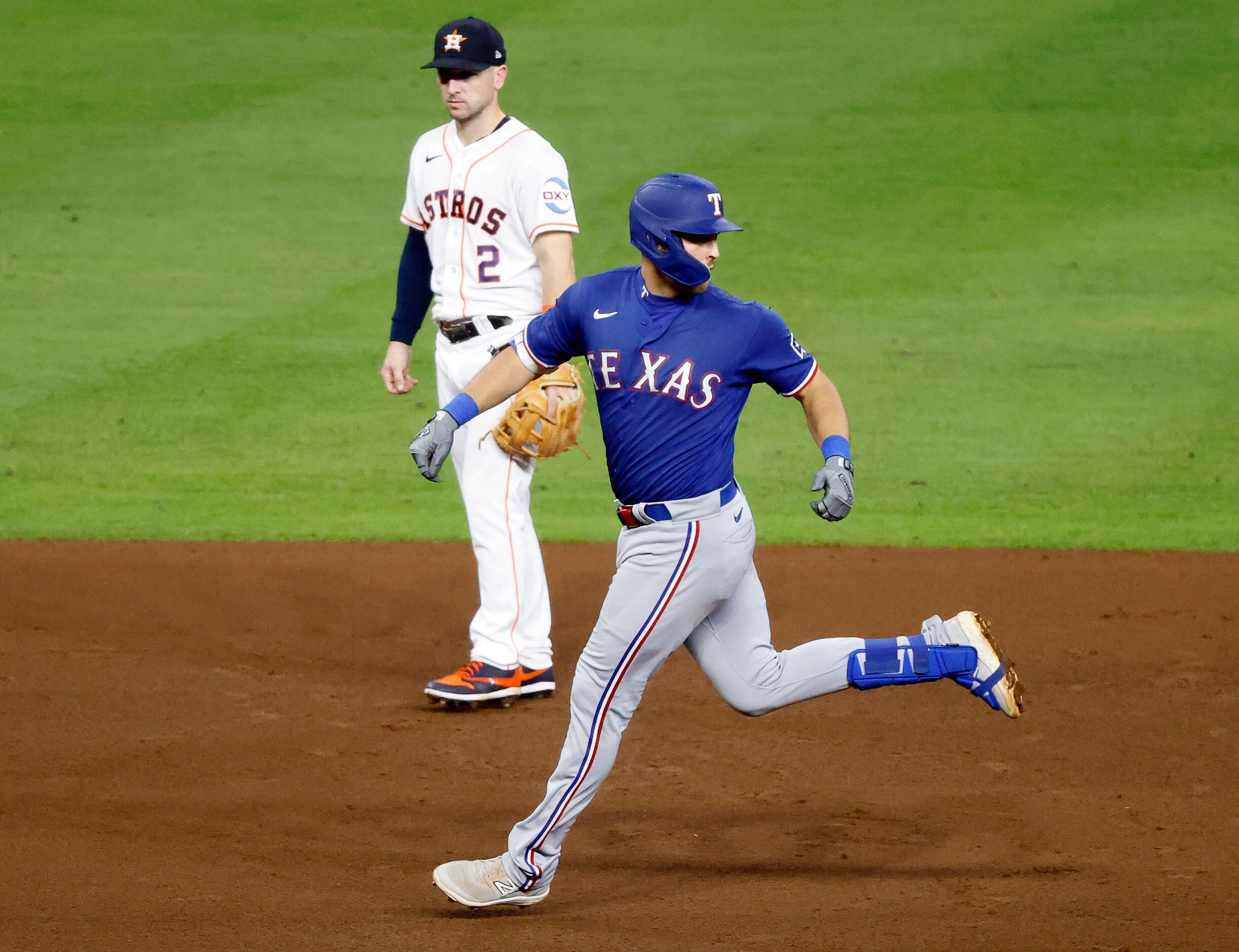 Texas Rangers Nathaniel Lowe (30) looks back over his shoulder to see if his two-run homer...