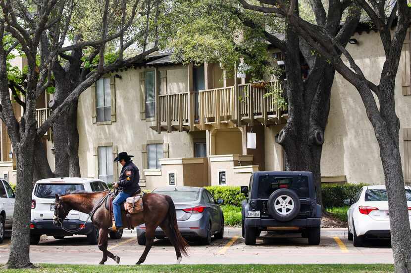 Horseback security guard Staci Smith patrols The Village apartments Wednesday, April 1, 2020...