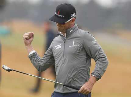Zach Johnson of the US celebrates after putting on the 18th green during the second round of...