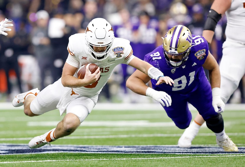 Texas Longhorns quarterback Quinn Ewers (3) dives for extra yards as Washington Huskies...