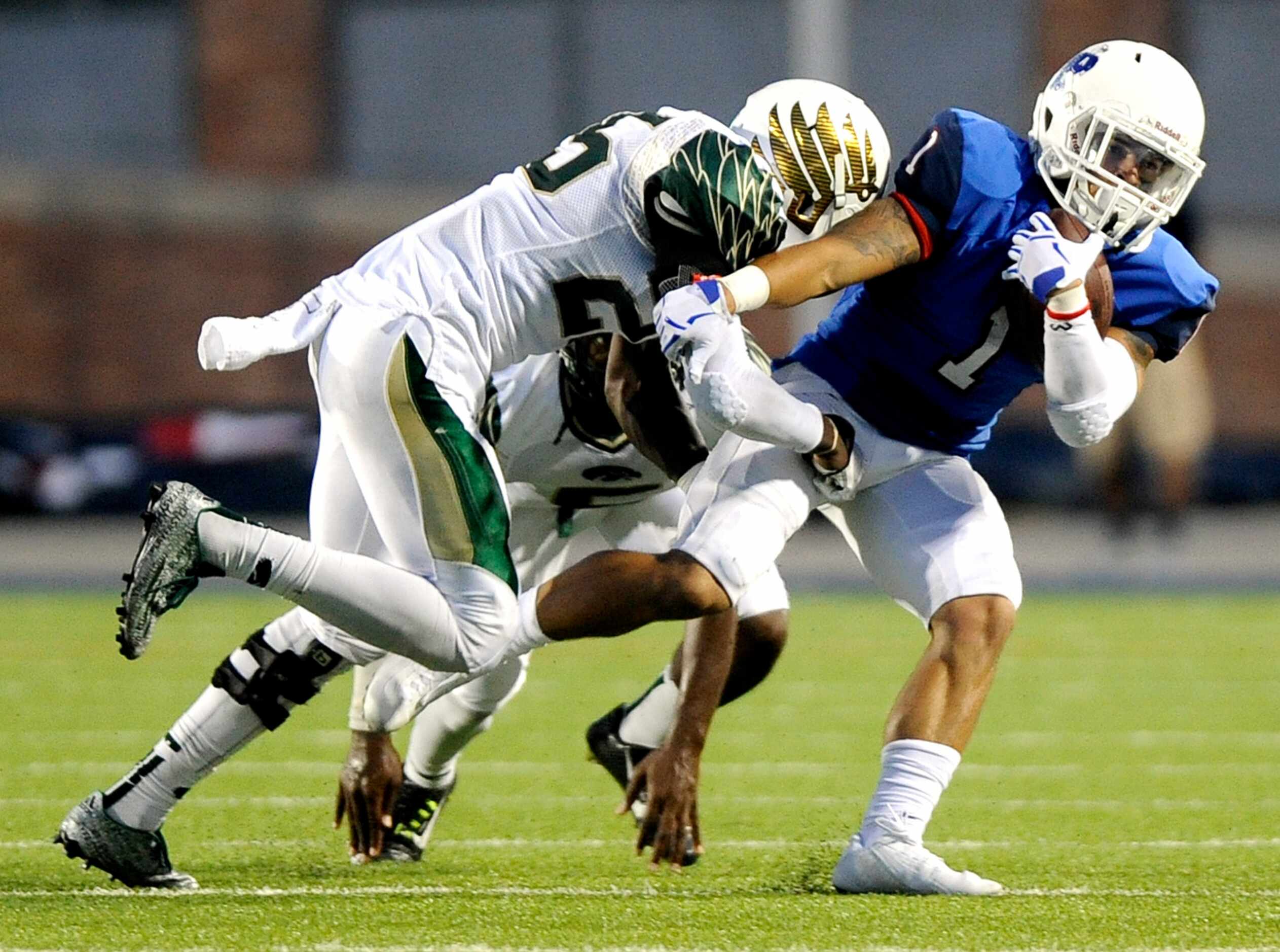 Allen's Kerry Hall (1) tries to run through a tackle by Viera's Jay Boyd (25) during a high...