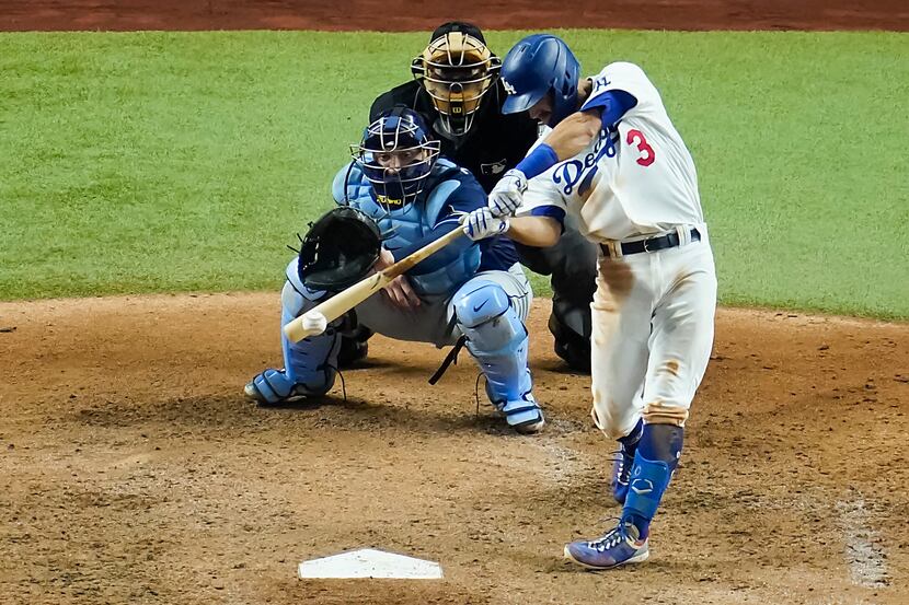 Los Angeles Dodgers second baseman Chris Taylor drives in a run with a single during the...