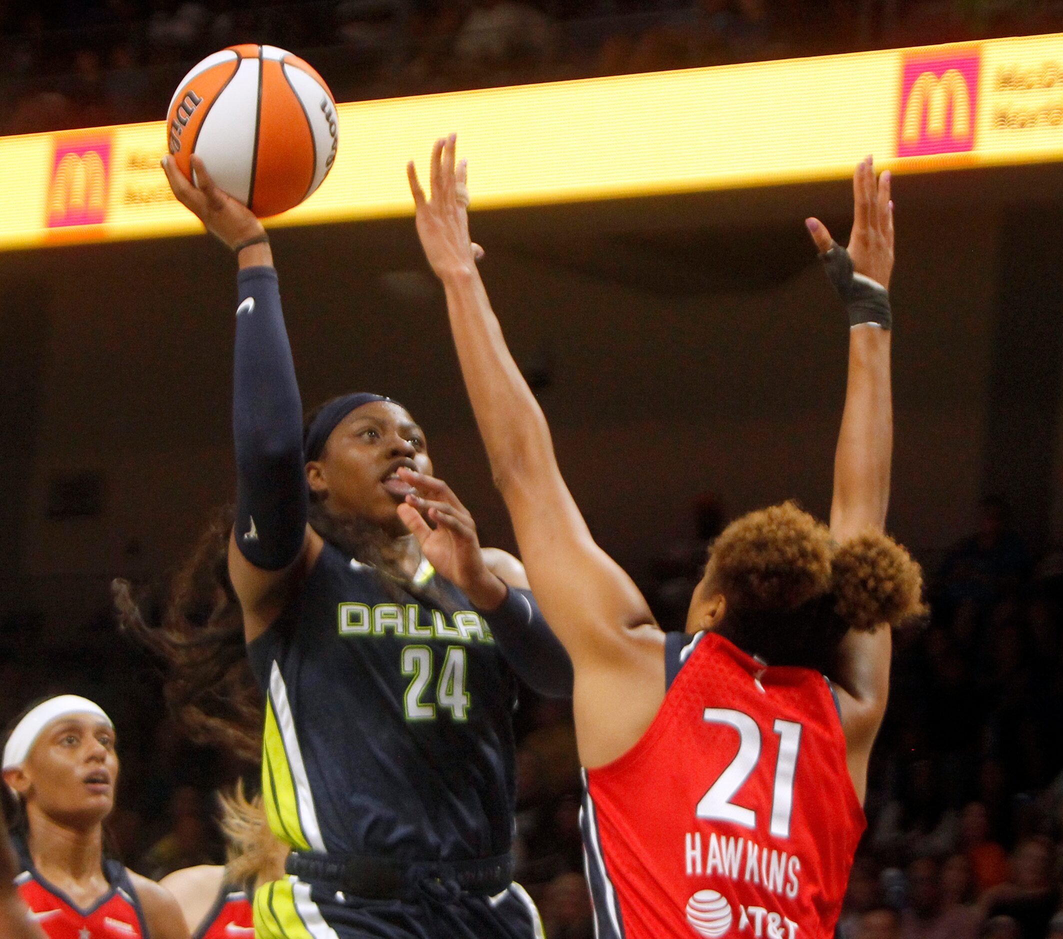 Dallas Wings guard Arike Ogunbowale (24) shoots a jump shot over the defense of Washington...