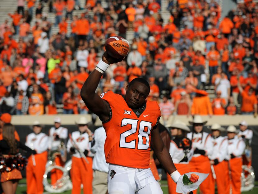 Oklahoma St wide receiver James Washington (28) waves to the crowd prior to a NCAA college...