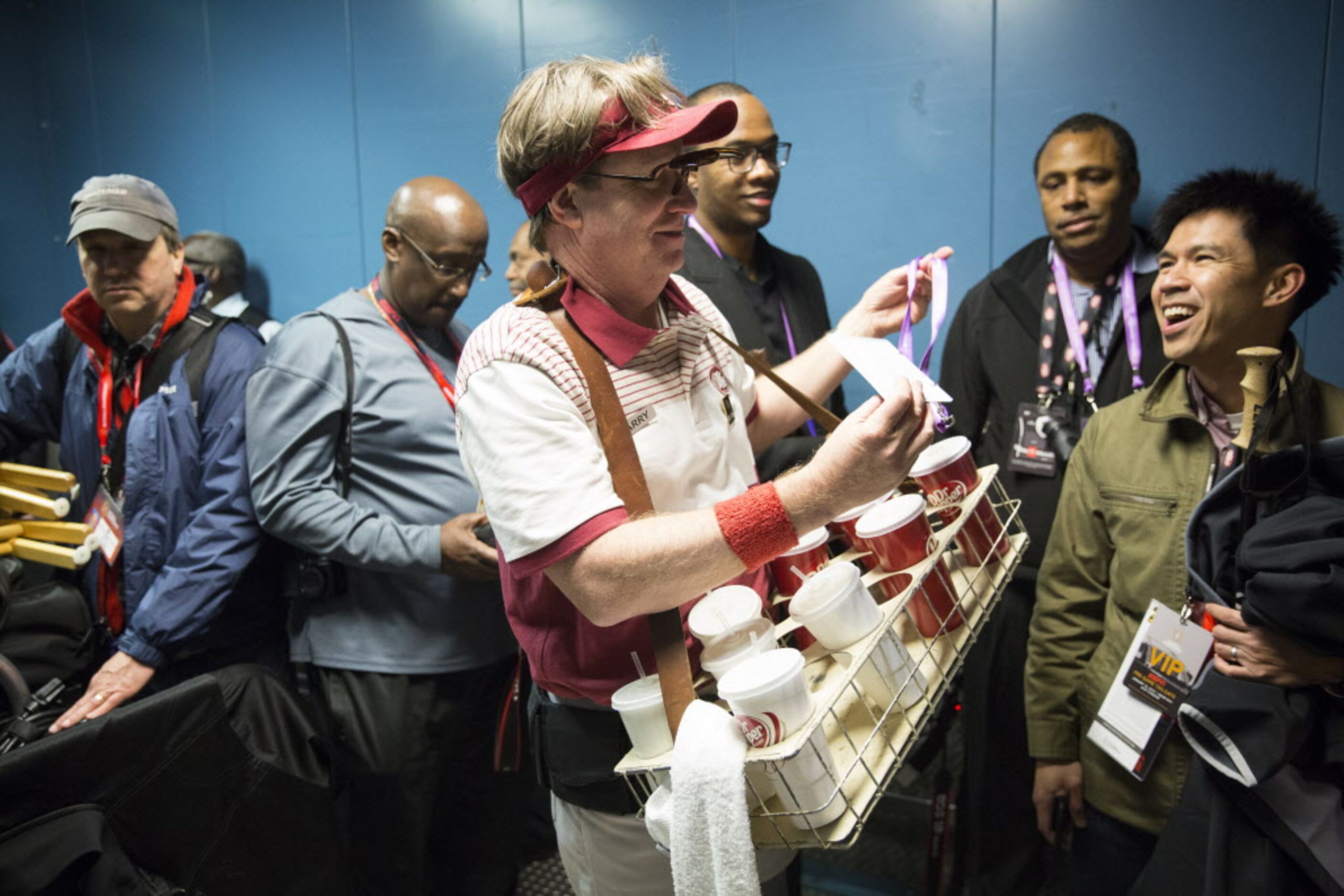 Larry, the Dr. Pepper guy, rides a freight elevator down to the field before the College...