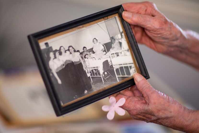 Hilda Tinker Rautenberg goes through a picture of her United Service Organizations trip at...